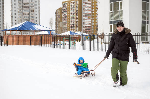 istock Young father and son sledding at winter time 638241552