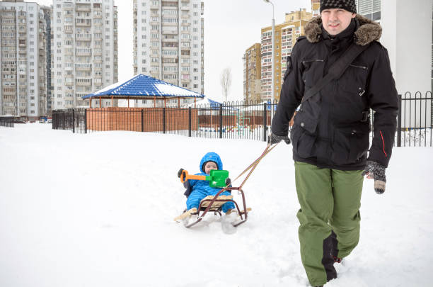 istock Young father and son sledding at winter time 638241704