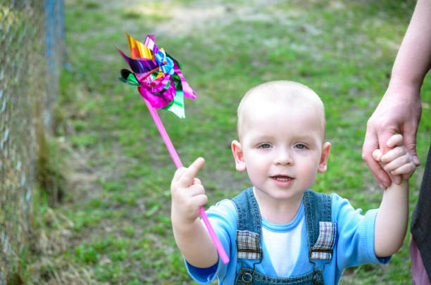 istock Cute little boy holding windmill show fuck. 638242000