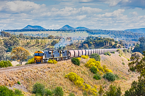 Grimy, coal train, scenic, picturesque, landscape: loaded coal train in picturesque Hunter Valley landscape bound for the export terminal.  Horizontal, painterly effect, logos and ID removed.