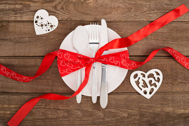 istock valentine's day background, white plate, fork, knife, tape hearts 638244438