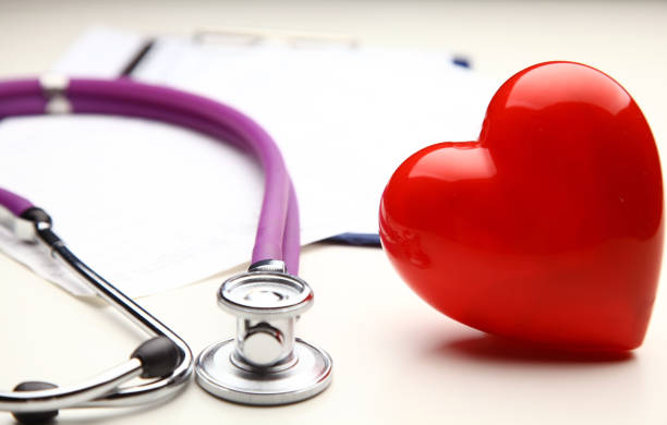 istock Heart with a stethoscope, isolated on wooden background 638248702