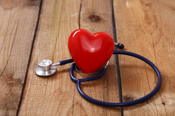istock Heart with a stethoscope, isolated on wooden background 638248924