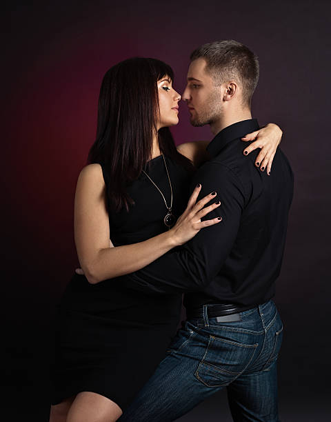 istock Young couple dancing on a dark background 638250670
