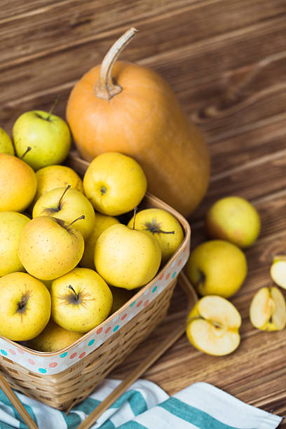 istock Basket with apples and pumpkins on wooden background 638251042