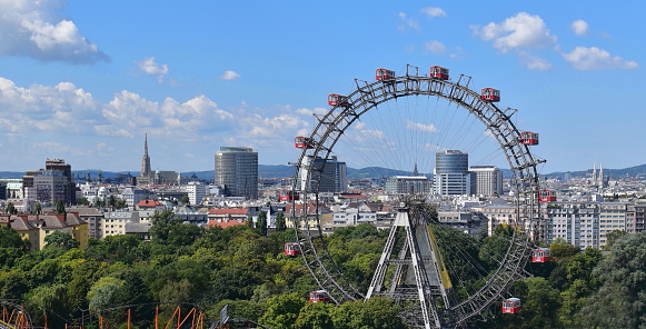 Montreal, Canada - August 29, 2022: famous ferris wheel and somebody is riding the flying fox at the amusement park.