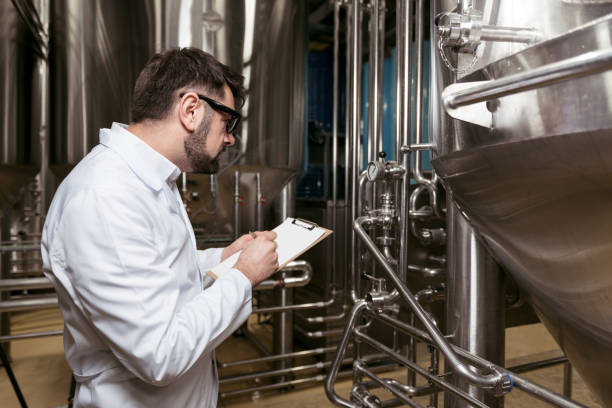 istock Concentrating man making notes at beer factory 638254078