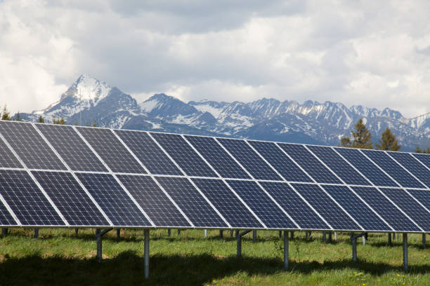 istock Solar panels with snowy mountains in the background 638254356