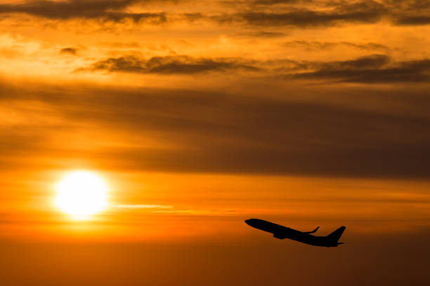 istock The plane flying towards a beautiful sunset 638255414