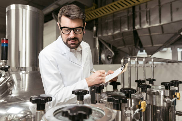 istock Concentrated man noting work results on beer factory 638255434