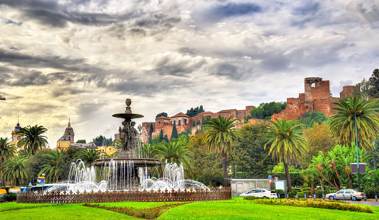 Tres Gracias Fountain and the Alcazaba Castle in Malaga - Adalusia, Spain