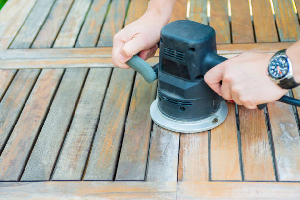 istock Close-up of carpenter's hands working with electric sander 638261034