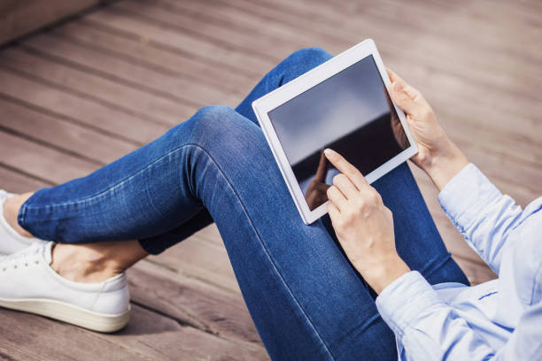 istock Girl using digital tablet outdoors 638261144