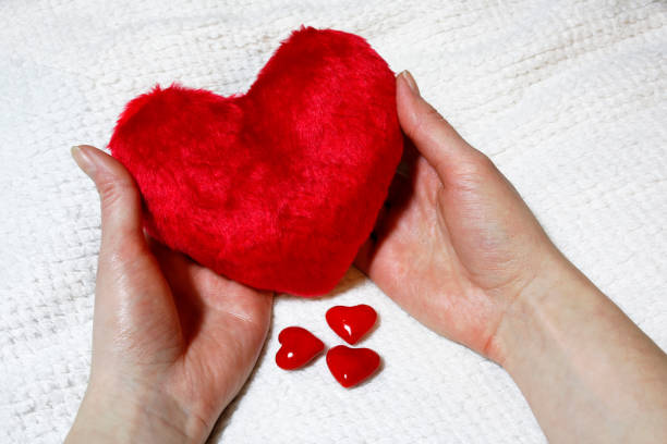 istock red heart in women hands 638261626