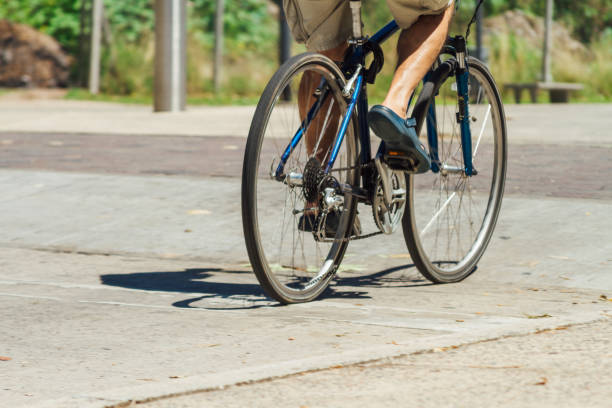 istock Man's legs cycling down the street 638264266