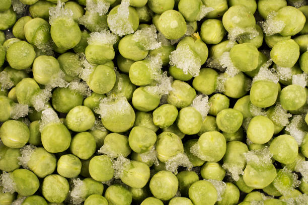 istock frozen green peas with ice crystals 638264970