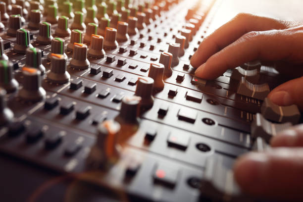Sound recording studio mixer desk Sound recording studio mixing desk with engineer or music producer sound mixer photos stock pictures, royalty-free photos & images