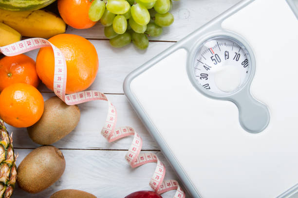 istock Stack of fruits, white weight scale and tailor meter 638269286