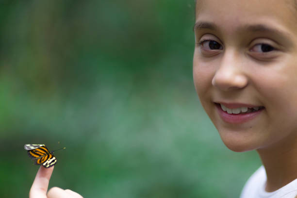 istock Happy Girl Holding a Butterfly 638272470