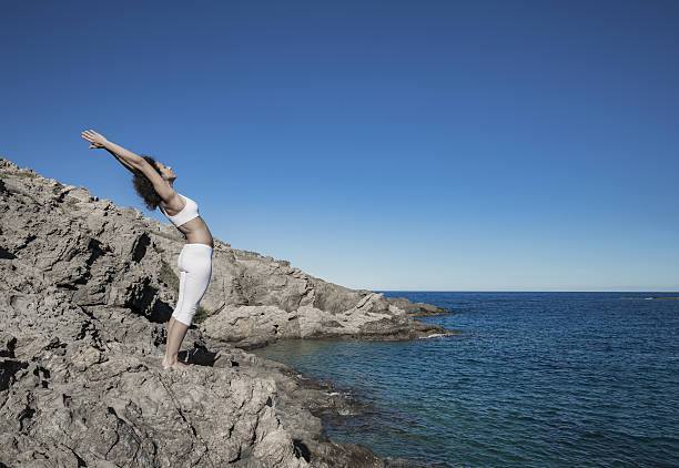 istock Woman doing a yoga sun salutation 638275860