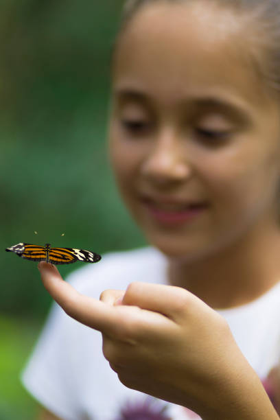 istock Happy Girl Holding a Butterfly 638278040