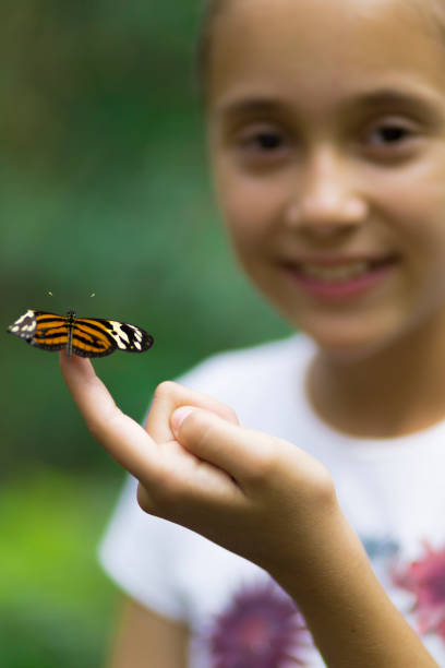 istock Happy Girl Holding a Butterfly 638278152