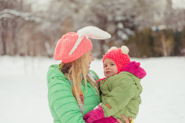 istock Winter. Mom with a child playing with snow. 638278504
