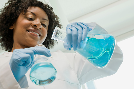 Scientist mixing chemicals in laboratory