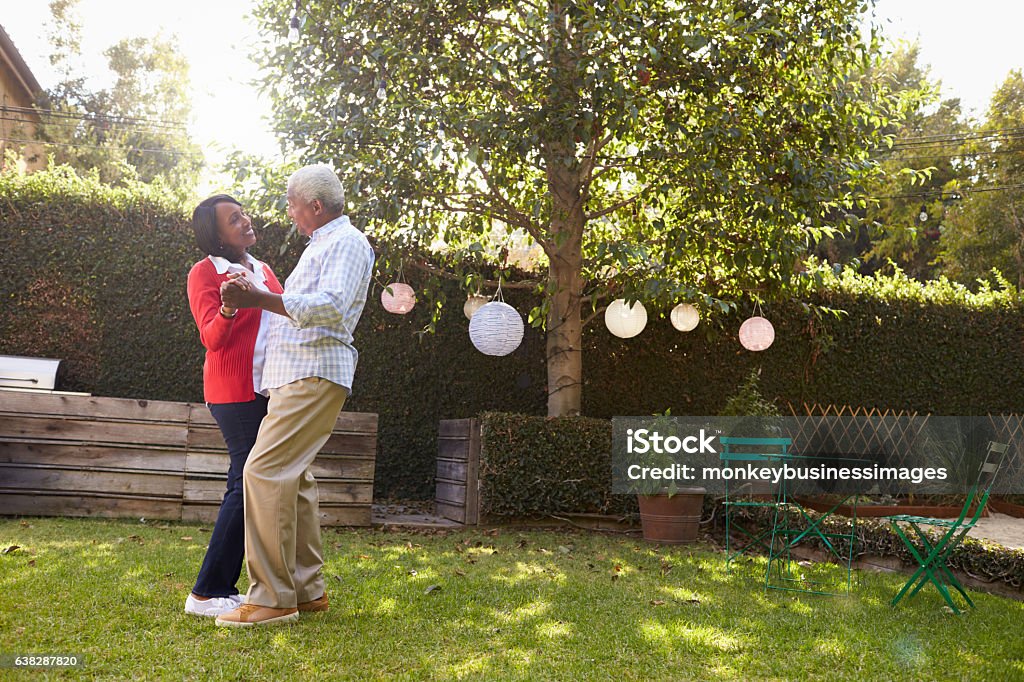 Senior black couple dance in their back garden, full length Couple - Relationship Stock Photo
