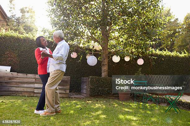 Senior Black Couple Dance In Their Back Garden Full Length Stock Photo - Download Image Now