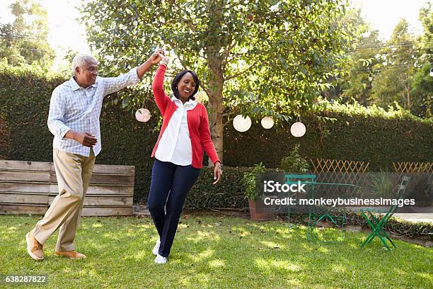 Senior Black Couple Dance In Their Back Garden Full Length Stock Photo - Download Image Now