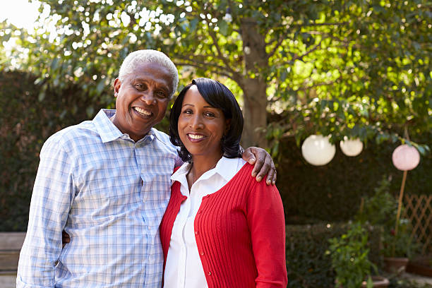 istock Senior black couple in their garden looking to camera 638287828