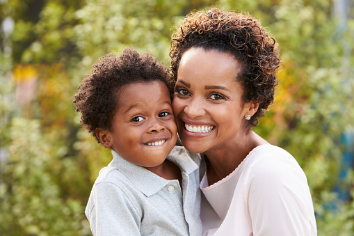 Portrait of young African American mother with toddler son