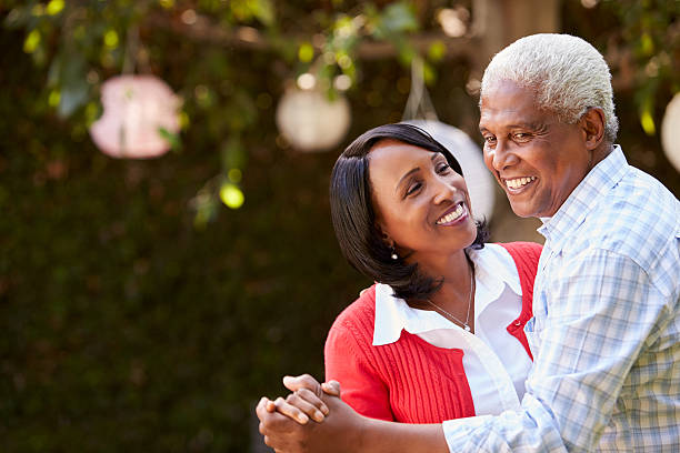 istock Senior black couple dancing in their backyard, close up 638288106