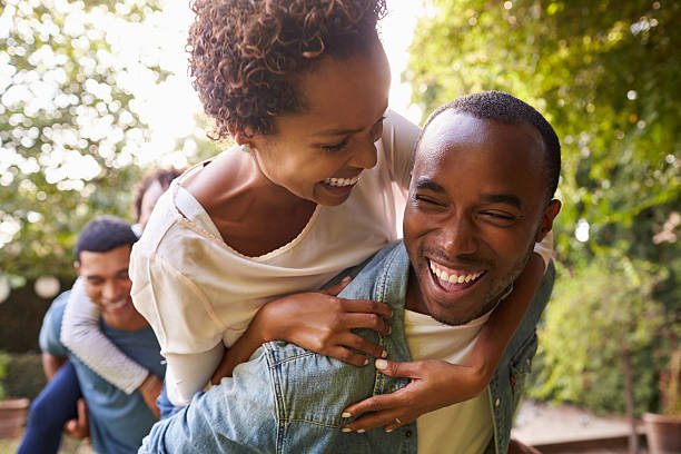 istock Two adult black couples piggybacking looking at each other 638288380