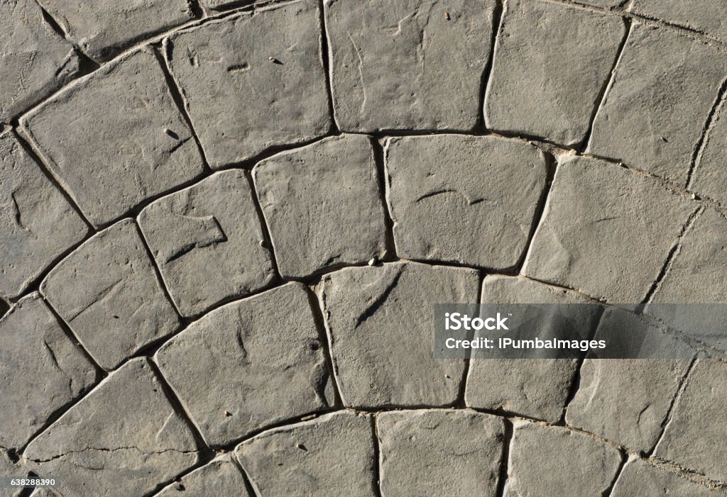 Stamped concrete pavement outdoor, mimics cobblestones circular pattern with waves Stamped concrete pavement outdoor, mimics cobblestones circular pattern with waves, flooring exterior, decorative appearance colors and textures of paving cobble stone, top view Abstract Stock Photo