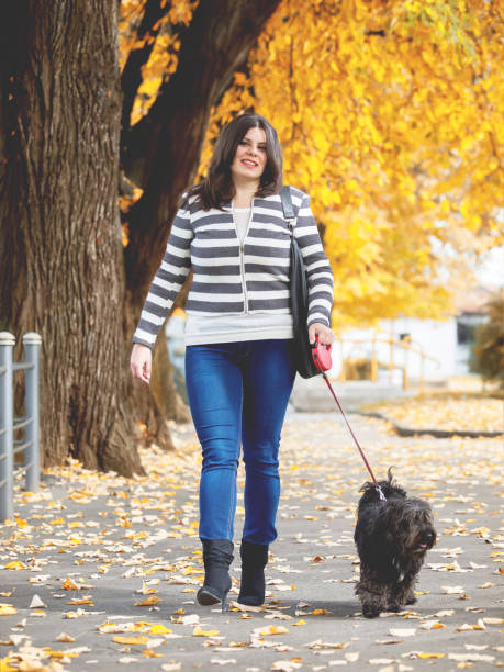 istock young woman walking with her Dog 638288976