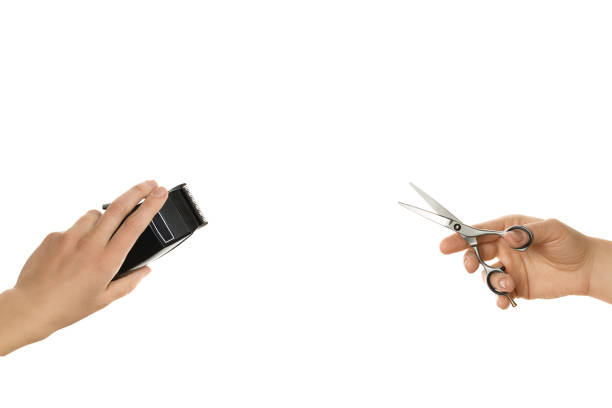 istock hands holding hair clipper and scissor, isolated on white 638290266