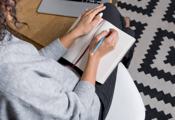 istock Modern businesswoman writing into her personal planner 638291646
