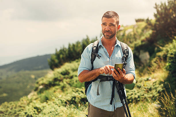 istock Male hiker texting in the mountain 638292570
