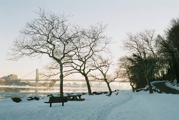 Palisades Park Wintry View Palisades Park, N.J. with a view of the George Washington Bridge over a frozen river. gwb stock pictures, royalty-free photos & images