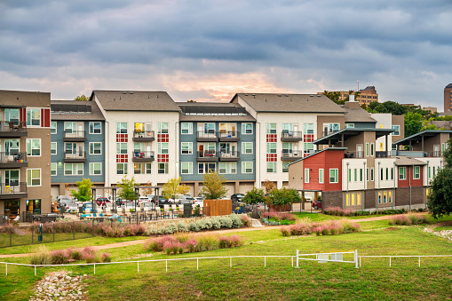 Stock photo of condominium apartment buildings with parking lot and back yard in Dallas, Texas, USA.