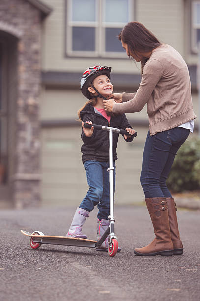 istock A mother is helping her daughter put on a bicycle 638299268