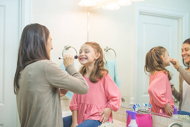 istock An ethnic mother is doing her young daughters makeup 638299336