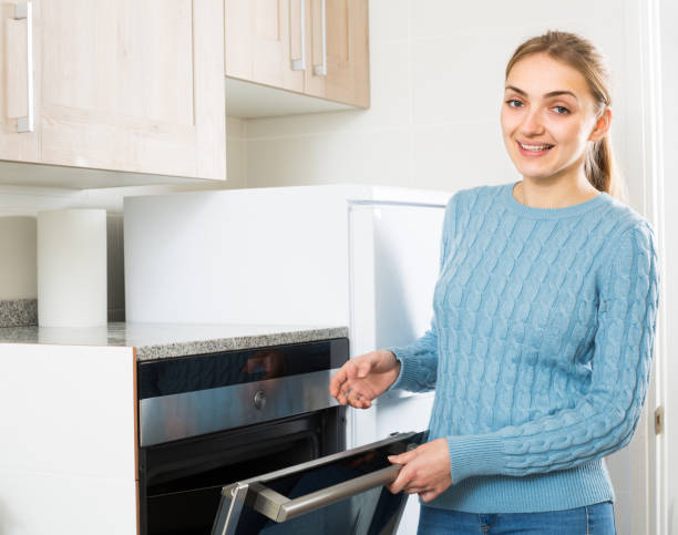 istock Girl near kitchen oven at home 638299364