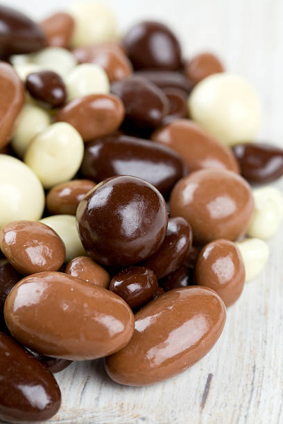 istock chocolate covered nuts and raisins on wooden surface 638299652
