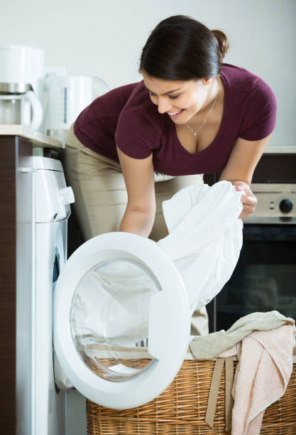 istock Young woman  near washing machine 638300190