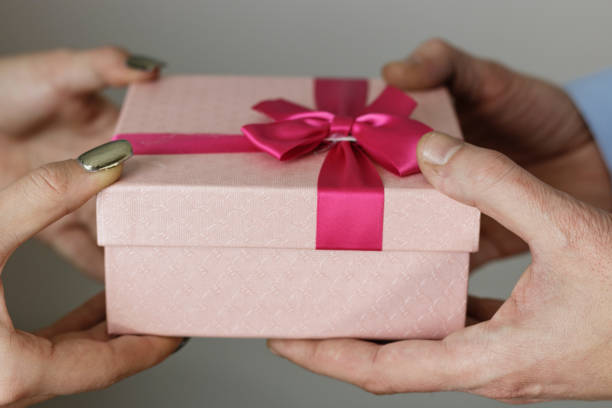 istock Boyfriend gives his girlfriend a gift box 638302702