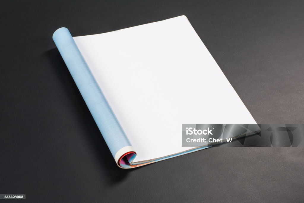 Mock-up magazines or catalog on black chalkboard background. Mock-up magazine or catalog on black chalkboard. Blank page or notepad on black table background. Blank page or notepad for mockups or simulations. Magazine - Publication Stock Photo