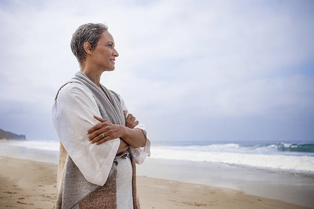 istock Senior Black Woman Relaxing on Beach 638304258